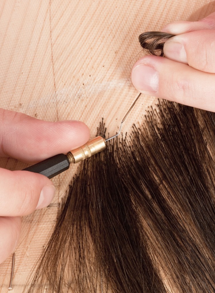 Wig hair ventilation services.  Picture of a wig maker adding single flat knots.
